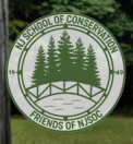 Organization logo: green text in circle with graphic of 5 pine trees overlooking bridge & river