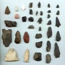 photo of many stone tools including arrowheads
