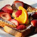 photo of strawberries and an orange on french toast
