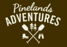 Pinelands Adventures logo-silhouette of 2 trees, 2 canoe paddles, a boot, and binoculars on brown background with text